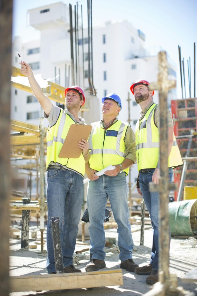 Three construction workers in construction site