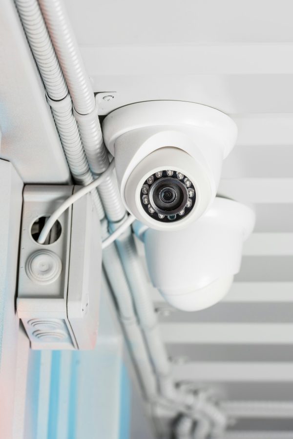 white security camera on ceiling, home security system concept